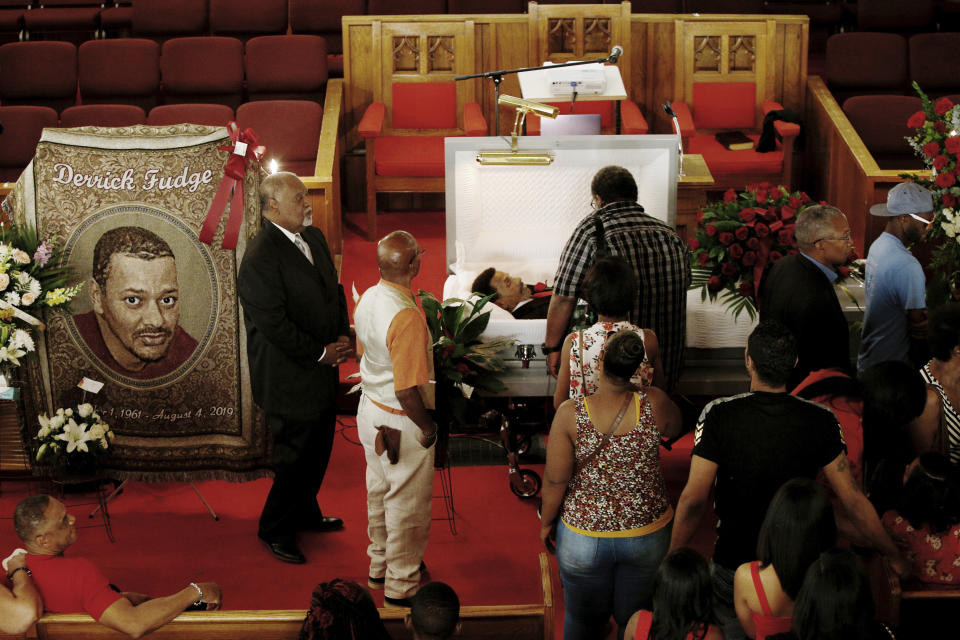 Friends and family mourn Derrick Fudge on Saturday, Aug. 10, 2019, at a church in Springfield, Ohio. Fudge, 57, was the oldest of nine who were killed when a gunman opened fire outside a bar early Sunday in Dayton, Ohio. (AP Photo/Angie Wang)