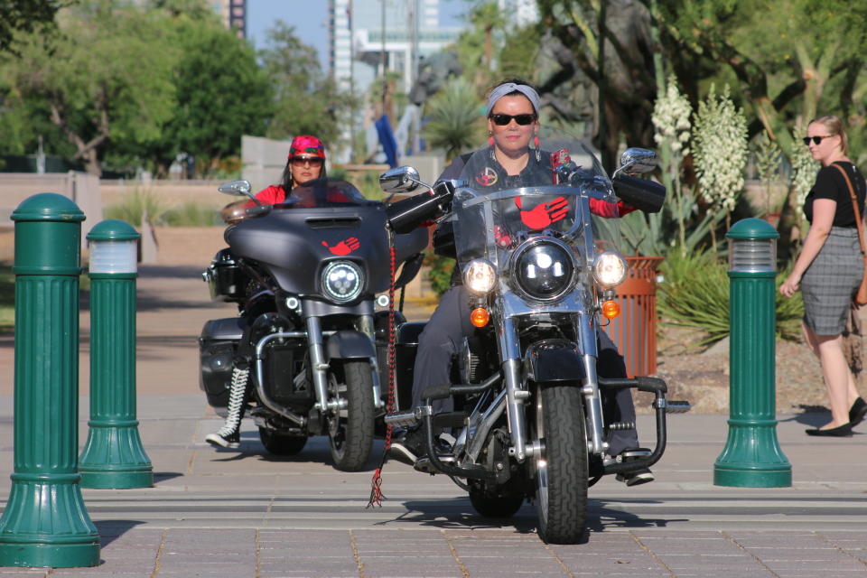 Shelly Denny, front, was among the riders from Medicine Wheel Ride who rode their bikes to the Arizona State Capitol in Phoenix, Wednesday, May 5, 2021, to raise awareness for missing and murdered Indigenous women and girls. (AP Photo/Cheyanne Mumphrey)