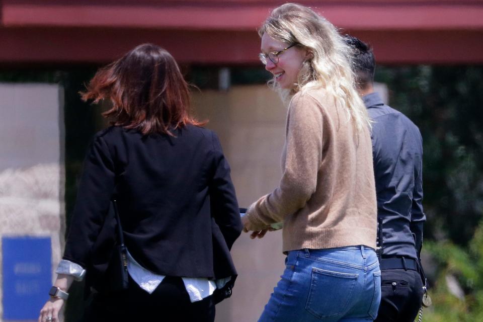 Disgraced Theranos CEO Elizabeth Holmes, center, is escorted by prison officials into a federal women’s prison camp on Tuesday, May 30, 2023, in Bryan, Texas. Holmes will spend the next 11 years serving her sentence for overseeing an infamous blood-testing hoax.