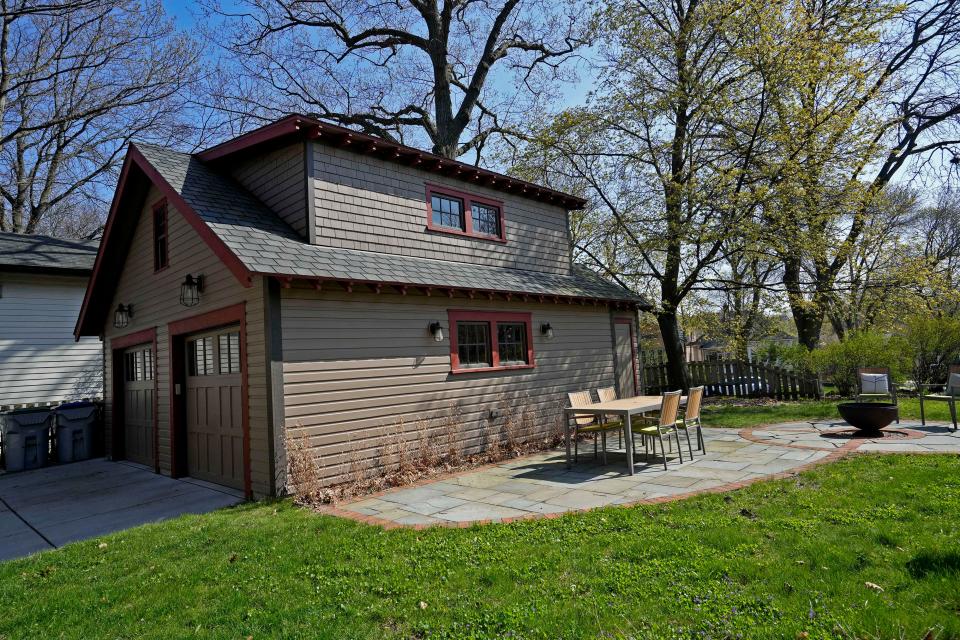 Sarah Frecska had this garage built after a tree fell on the previous one. She tried to match the style but improved the dormer and added a patio.