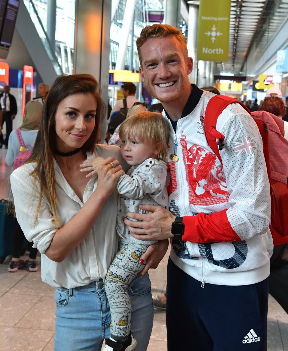 Greg Rutherford poses for a photograph with his partner Susie Verrill and son Milo after arriving on a British Airways flight from Rio de Janeiro to London Heathrow Airport Terminal 5 on August 17, 2016 (Getty Images)