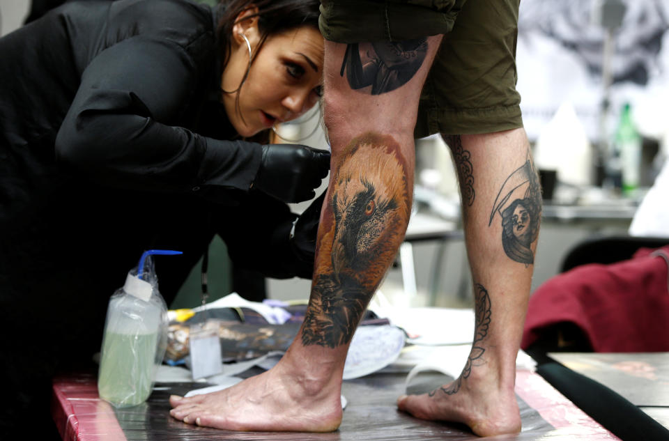 <p>A tattoo artist prepares a design on the leg of a man at the London Tattoo Convention, in London, Britain, Sept. 23, 2017. (Photo: Peter Nicholls/Reuters) </p>