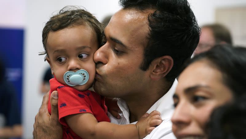 Republican presidential candidate businessman Vivek Ramaswamy holds his son Arjun during a fundraising event for U.S. Rep. Ashley Hinson, R-Iowa, on Sunday, Aug. 6, 2023, in Cedar Rapids, Iowa.