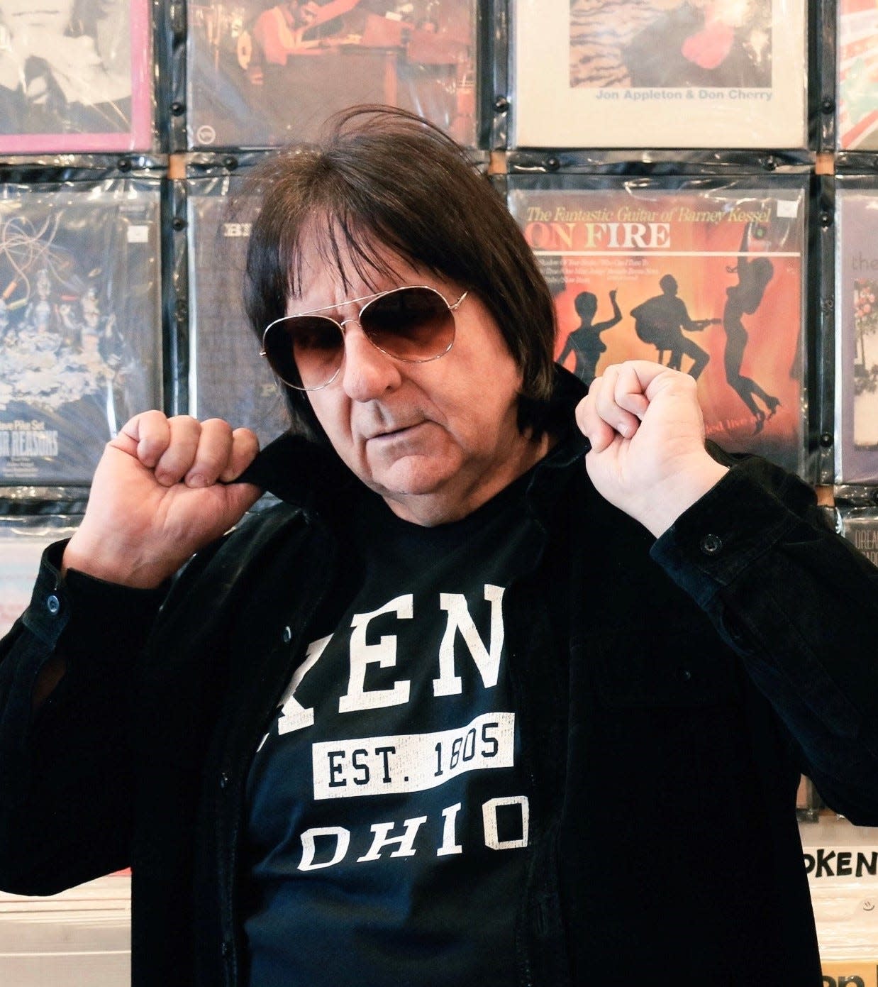 Guitarist Michael Purkhiser, a Stow native, wears a Kent shirt while visiting a Los Angeles record store.