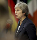 British Prime Minister Theresa May speaks with the media as she arrives for an EU summit in Brussels, Wednesday, Oct. 17, 2018. European Union leaders are converging on Brussels for what had been billed as a "moment of truth" Brexit summit but which now holds little promise for a breakthrough. (AP Photo/Olivier Matthys)