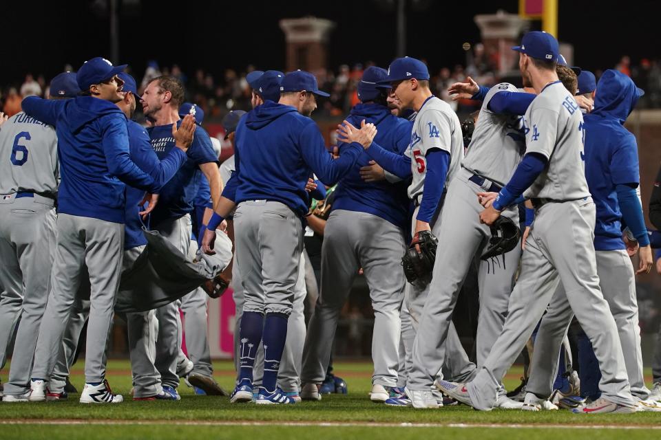 The Dodgers celebrate after defeating the Giants in Game 5.