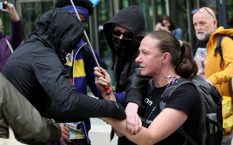 Ms Kovacevic getting 'pushed and pulled' by a protester - Barbara Cook / Alamy Live News