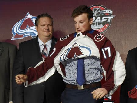 June 23, 2017; Chicago, IL, USA; Cale Makar puts on a team jersey after being selected as the number four overall pick to the Colorado Avalanche in the first round of the 2017 NHL Draft at the United Center. Mandatory Credit: David Banks-USA TODAY Sports