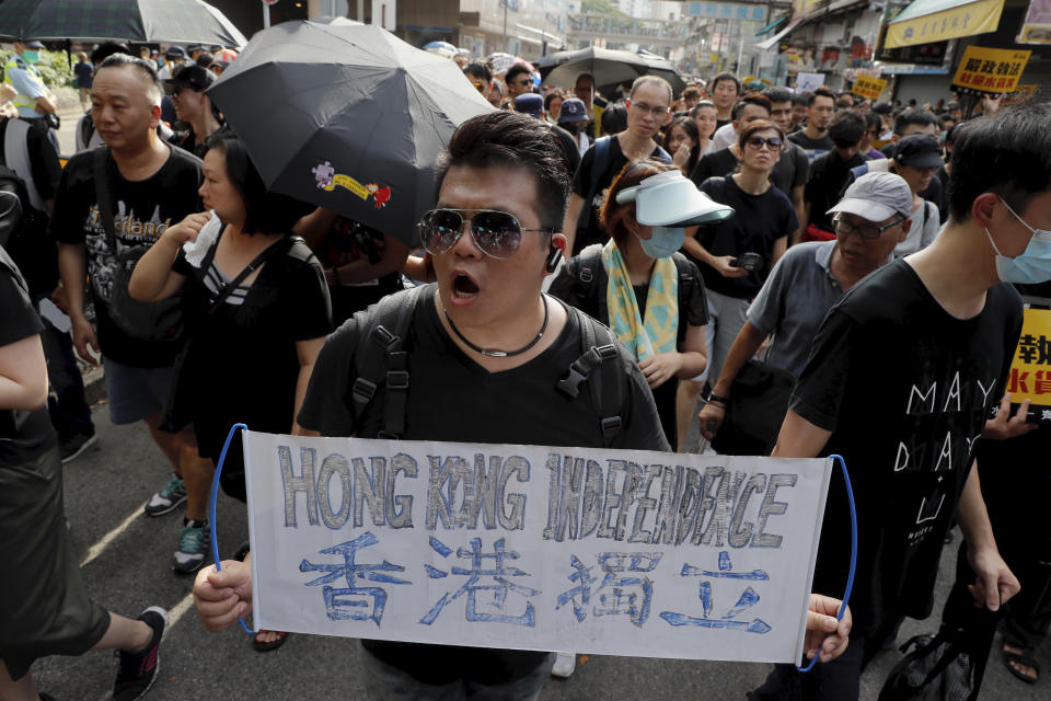 A protester holds up a banner calling for independence, in Hong Kong in Saturday, July 13, 2019. Several thousand people marched in Hong Kong on Saturday against traders from mainland China in what is fast becoming a summer of unrest in the semi-autonomous Chinese territory. (AP Photo/Kin Cheung)