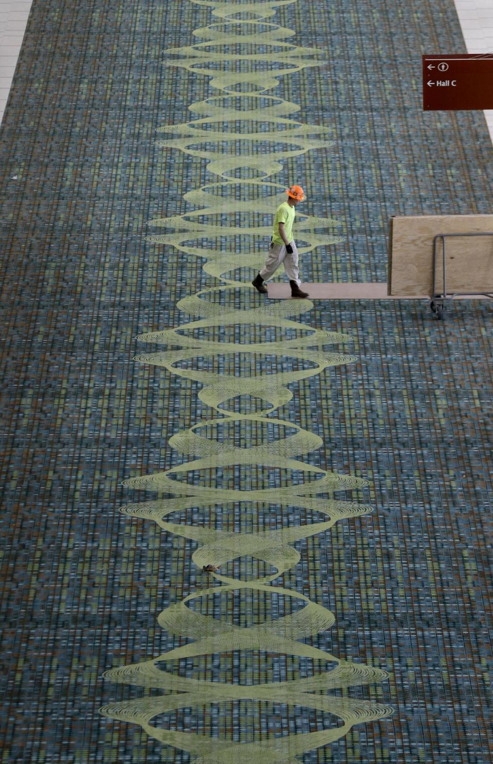 This April 12, 2013, photo shows carpet decorated with a sound wave in the Music City Center in Nashville, Tenn. Nashville's new convention center is transforming the look of downtown with its wavy roof dominating six city blocks, but tourism officials hope the eye-catching facility will also show business travelers a revitalized Music City. (A P Photo/Mark Humphrey)