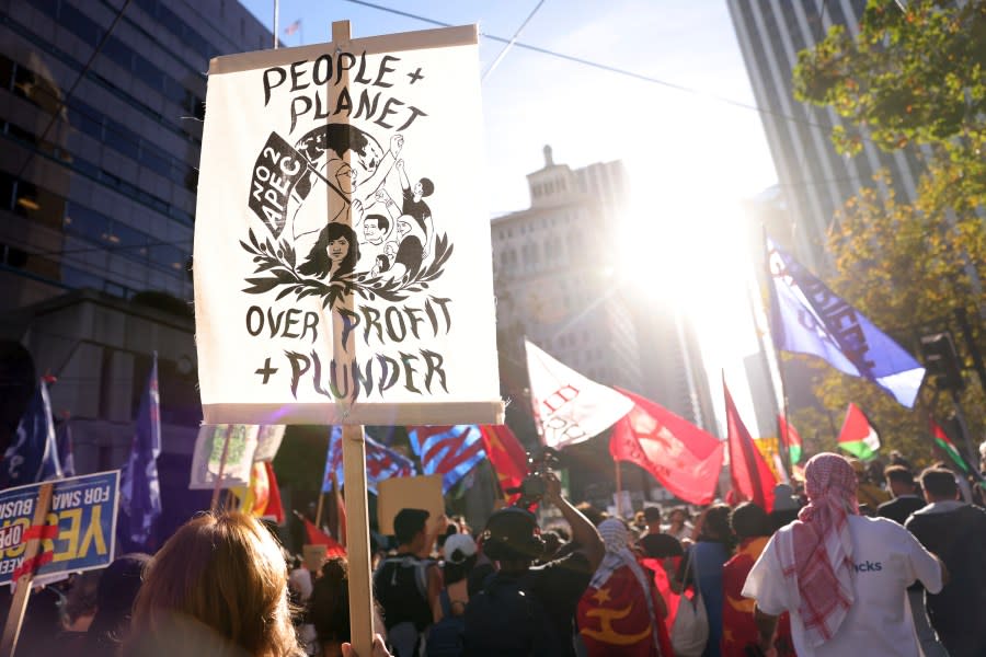 “No to APEC” protesters march on Market Street in San Francisco, Sunday, Nov. 12, 2023. (Scott Strazzante/San Francisco Chronicle via AP)