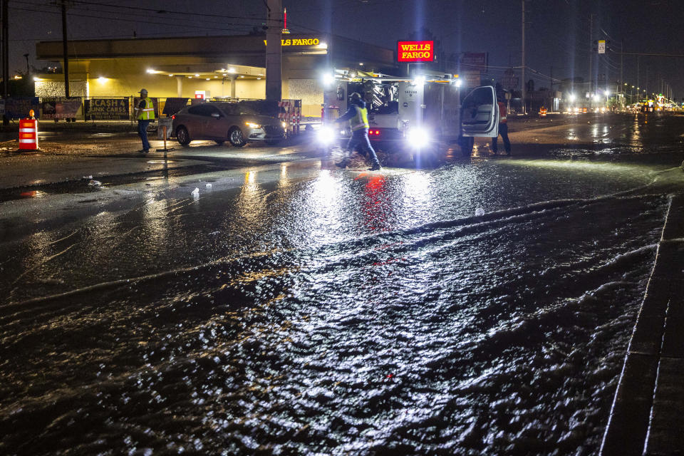 A road crew blocks the flooded Charleston Blvd. at South Spencer Street as a powerful storm moves through the area on Thursday, July 28, 2022, in Las Vegas. (L.E. Baskow/Las Vegas Review-Journal via AP)