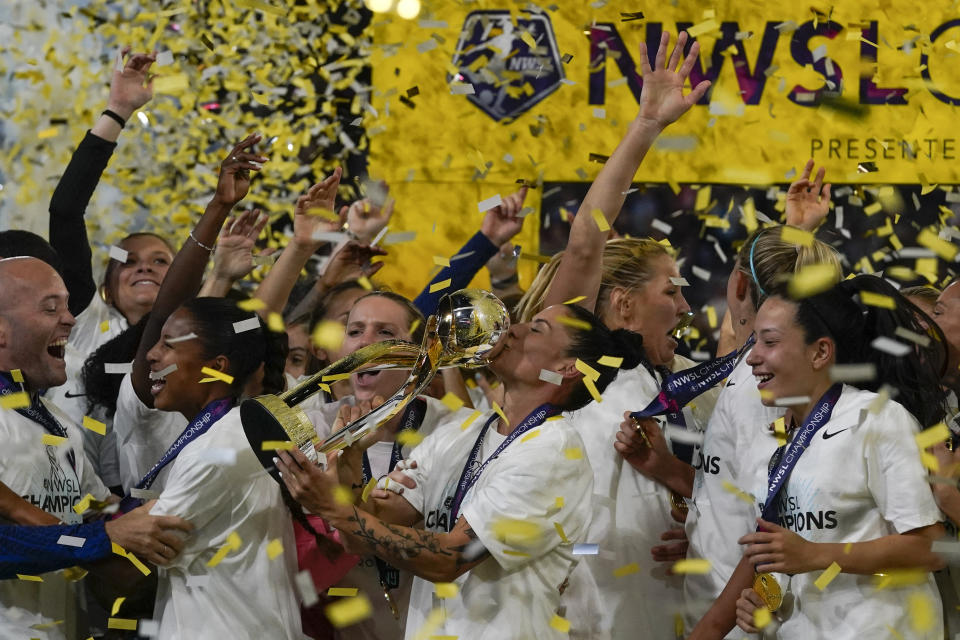 NJ/NY Gotham defender Ali Krieger, center, kisses the trophy after NJ/NY Gotham defeated OL Reign 2-1 in the NWSL Championship soccer game, Saturday, Nov. 11, 2023, in San Diego. (AP Photo/Gregory Bull)