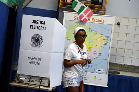 Brazilians cast their votes in a runoff election, in Rio de Janeiro, Brazil October 28, 2018. REUTERS/Pilar Olivares