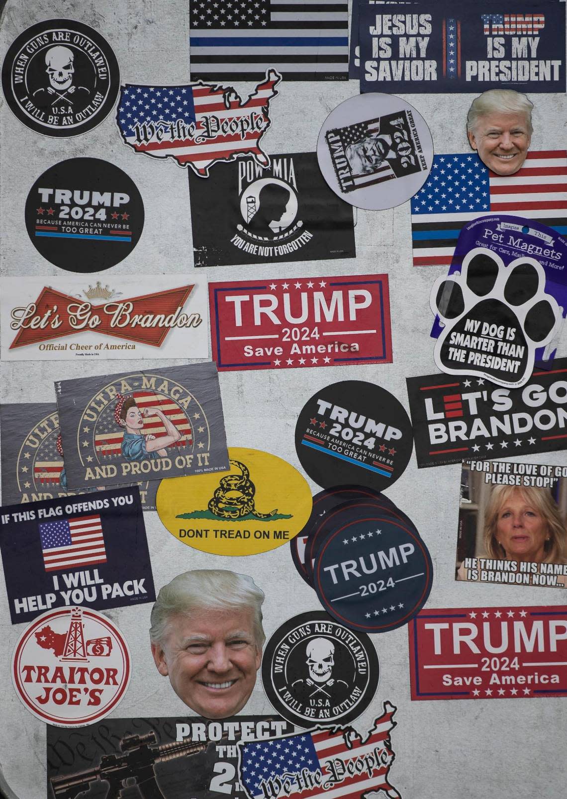 A Trump supporter displays stickers while gathering outside of Trump National Doral Miami on Monday, June 12, 2023, in Doral, Fla. Supporters of former President Donald Trump gathered outside his hotel one day before his expected arraignment in federal court.