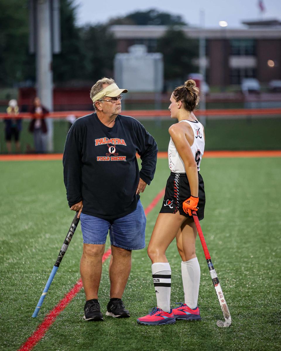 Olivia Kirkpatrick and head coach Kent Harshman go over strategy during a regular-season game.