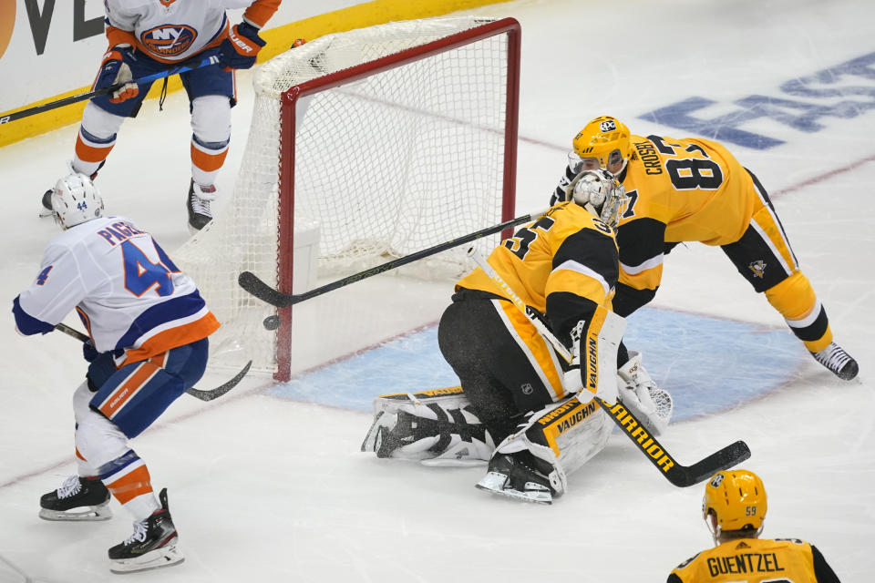 New York Islanders' Jean-Gabriel Pageau (44) can't get a rebound behind Pittsburgh Penguins goaltender Tristan Jarry (35) with help from Sidney Crosby (87) during the first period in Game 2 of an NHL hockey Stanley Cup first-round playoff series in Pittsburgh, Tuesday, May 18, 2021. (AP Photo/Gene J. Puskar)