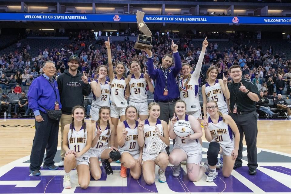 Bret Harte Bullfrogs pose for a photo with the trophy after winning the CIF Division V girls basketball State Championship against the Marina Vikings on Saturday, March 11, 2023, at Golden 1 Center in Sacramento. The Bullfrogs defeated the Vikings 62-39. (SARA NEVIS/FOR THE RECORD)