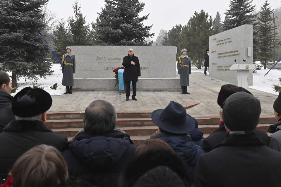 FILE - In this photo released by Kazakhstan's Presidential Press Service, Kazakhstan's President Kassym-Jomart Tokayev attends an unveiling a memorial to the hundreds of people killed amid the worst unrest in Kazakhstan's three decades of independence in January of 2022 in Republic Square, in the heart of the country's former capital Almaty, Kazakhstan, Friday, Dec. 23, 2022. Words on the stark concrete "Reverence" memorial speak of the need for unity and harmony in the former Soviet country. But a year after calm was restored and a state of emergency lifted on Jan. 20, 2022, both appear elusive in the country of 19 million. (Kazakhstan's Presidential Press Service via AP, File)