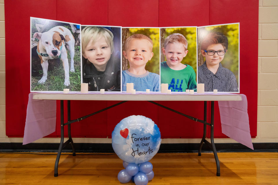 The auditorium at Lincoln Intermediate School in Mason City was bedecked Wednesday with photos of the four Mcluer boys and their dog.