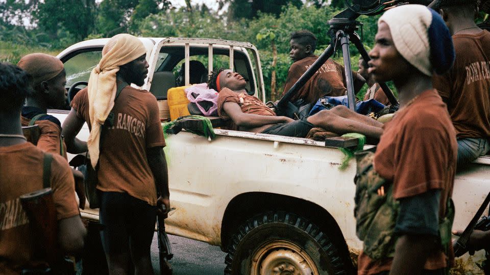 A casualty from an ambush lies in the back of a 'technical' during the push on Liberia's capital Monrovia in June 2003. - Tim Hetherington