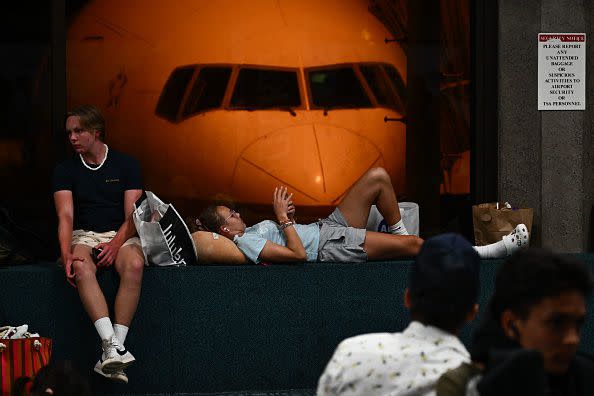 Passengers wait for delayed and canceled flights off the island as thousands of passengers were stranded at the Kahului Airport (OGG) in the aftermath of wildfires in western Maui in Kahului, Hawaii on August 9, 2023. The death toll from a wildfire that turned a historic Hawaiian town to ashes has risen to 36 people, officials said on August 9. (Photo by Patrick T. Fallon / AFP) (Photo by PATRICK T. FALLON/AFP via Getty Images)