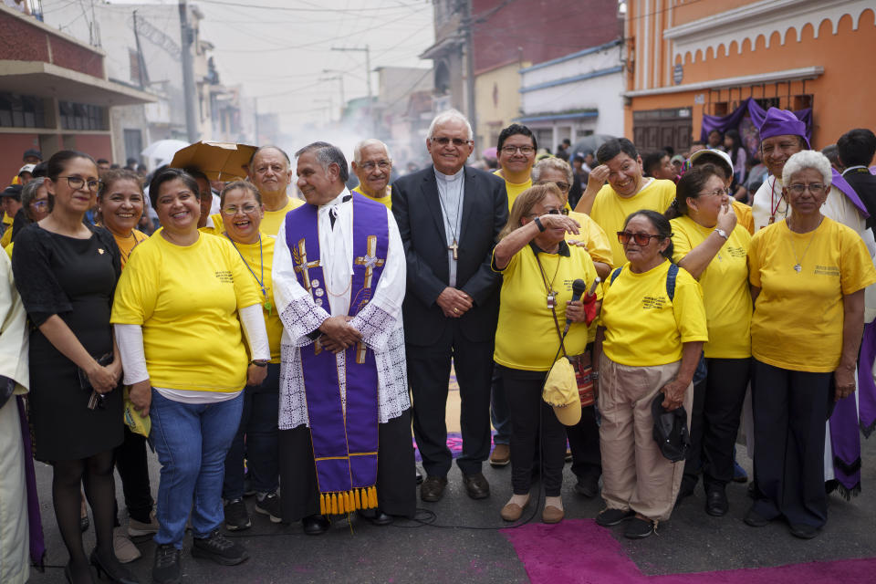 Cardinal Alvaro Ramazzini, center, and Catholic volunteers wait for the arrival of a religious procession, in Guatemala City, Saturday, March 23, 2024. Elevated by Pope Francis in 2019 to the top hierarchy of the Catholic Church, Ramazzini has continued his focus on the poor, the Indigenous and the migrant. (AP Photo/Moises Castillo)