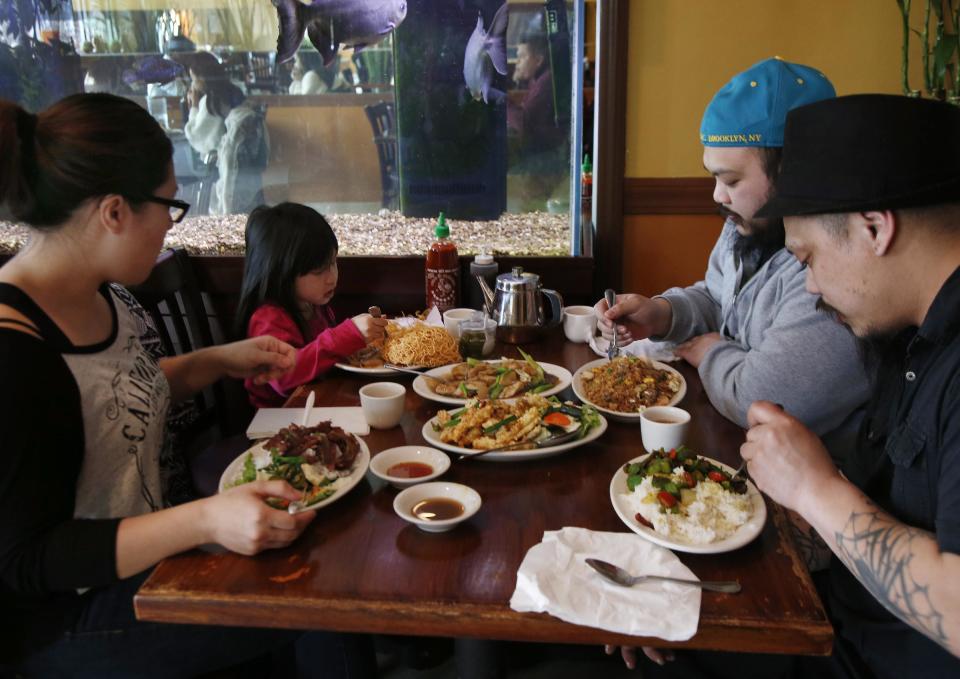 This March 14, 2014 photo shows patrons eating lunch at Simply Khmer, a Cambodian restaurant in Lowell, Mass. Simply Khmer is considered by some to offer the best _ and most authentic _ Cambodian food in Lowell. (AP Photo/Elise Amendola)