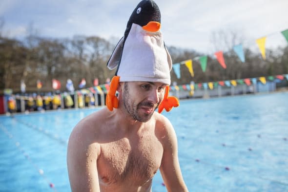 People take part in the 6th edition of the swimming race UK