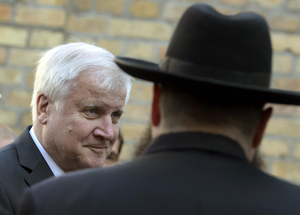 German Interior Minister Horst Seehofer arrives at a synagogue in Halle, Germany, Thursday, Oct. 10, 2019. A heavily armed assailant ranting about Jews tried to force his way into a synagogue in Germany on Yom Kippur, Judaism's holiest day, then shot two people to death nearby in an attack Wednesday that was livestreamed on a popular gaming site. (AP Photo/Jens Meyer)