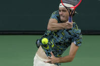 Taylor Fritz returns to Jannik Sinner, of Italy, at the BNP Paribas Open tennis tournament Thursday, March 16, 2023, in Indian Wells, Calif. (AP Photo/Mark J. Terrill)