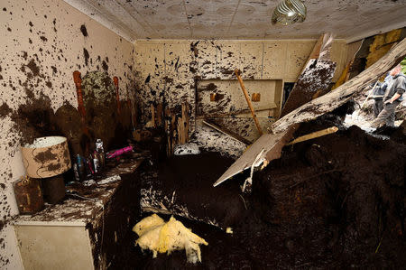 Bernie Kearney's bedroom in her destroyed home is seen, after a landslide carrying a boulder and her car came through the house, during torrential rains in Urris, County Donegal, Ireland August 24, 2017. REUTERS/Clodagh Kilcoyne