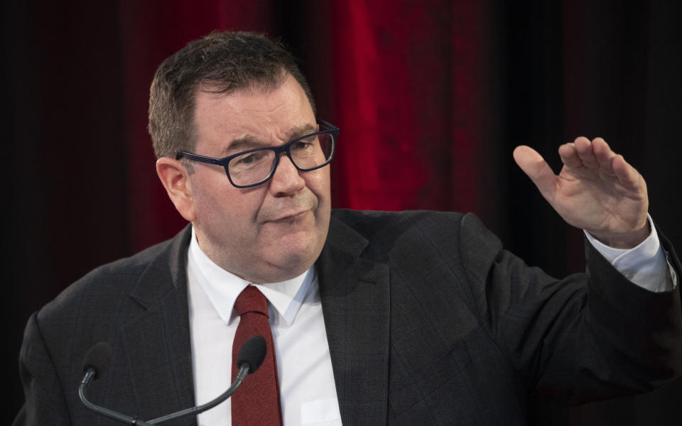 New Zealand Finance Minister Grant Robertson gestures during his presentation at the Budget lockup at Parliament in Wellington, New Zealand, Thursday, May 20, 2021. New Zealand plans to rebuild its Antarctic base and spend billions more on welfare payments as part of a spending program aimed at lifting the economy out of a coronavirus slump. (Mark Mitchell/NZ Herald via AP)
