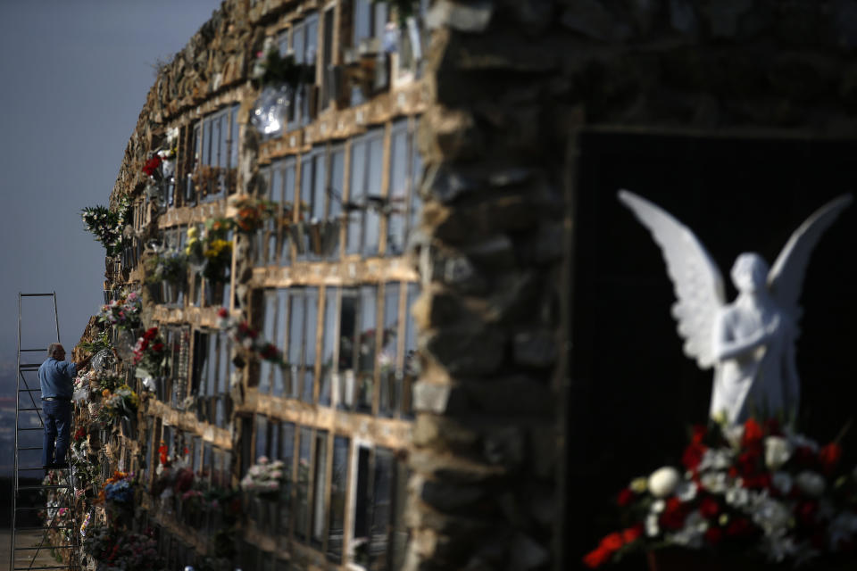 <p>A man places flowers on a grave during All Saints’ Day, a Catholic holiday to reflect on the saints and deceased relatives, at the Montjuic cemetery in Barcelona, Spain, Wednesday, Nov. 1, 2017. (Photo: Manu Fernandez/AP) </p>