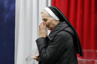 A catholic nun reacts after vote at a polling station in Warsaw, Poland, Sunday, Oct. 13, 2019. Poles are voting Sunday in a parliamentary election, that the ruling party of Jaroslaw Kaczynski is favored to win easily, buoyed by the popularity of its social conservatism and generous social spending policies that have reduced poverty. (AP Photo/Darko Bandic)