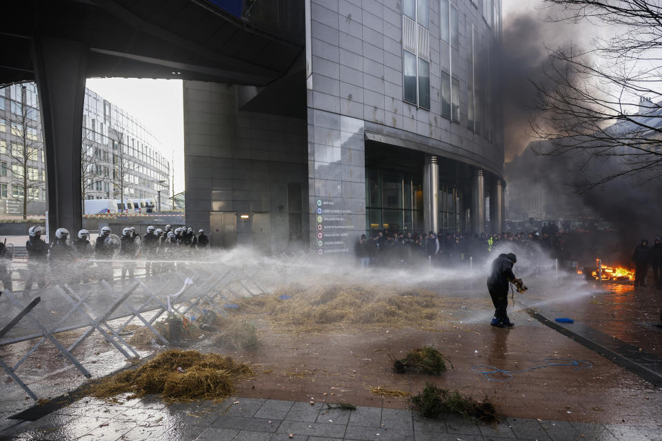 Anti riot police use water to disperse people during a protest by farmers outside the European Parliament as European leaders meet for an EU summit in Brussels, Thursday, Feb. 1, 2024. European Union leaders meet in Brussels for a one day summit to discuss the revision of the Multiannual Financial Framework 2021-2027, including support for Ukraine. (AP Photo/Thomas Padilla)