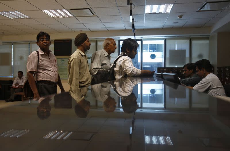 People line to submit their papers inside the Income Tax office in New Delhi