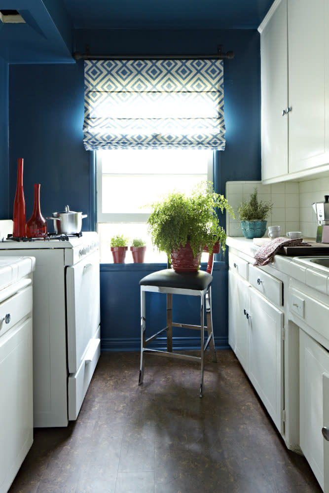 This publicity image released by Brian Patrick Flynn shows a kitchen designed in teal with white cabinets. Teal is one of designer Brian Patrick Flynn's go-to colors for adding bold, Caribbean style to interiors. To add a high-energy touch of summer to his own Los Angeles kitchen, Flynn covered the walls and ceiling in teal lacquer, pairing it with white through freshly painted cabinets and a geometric Roman shade. (AP Photo/Brian Patrick Flynn, Daniel Collopy)