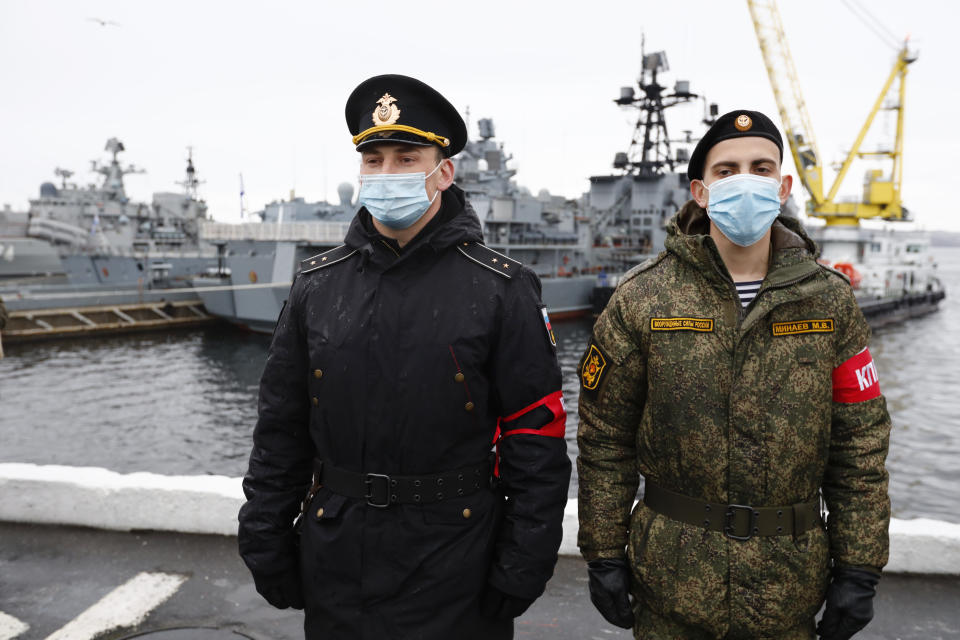 Russian sailors stand guard near the Northern Fleet's flagship, the Pyotr Veilikiy (Peter the Great) missile cruiser, at its Arctic base of Severomorsk, Russia, Thursday, May 13, 2021. Adm. Alexander Moiseyev, the commander of Russia's Northern Fleet griped Thursday about increased NATO's military activities near the country's borders, describing them as a threat to regional security. (AP Photo/Alexander Zemlianichenko)