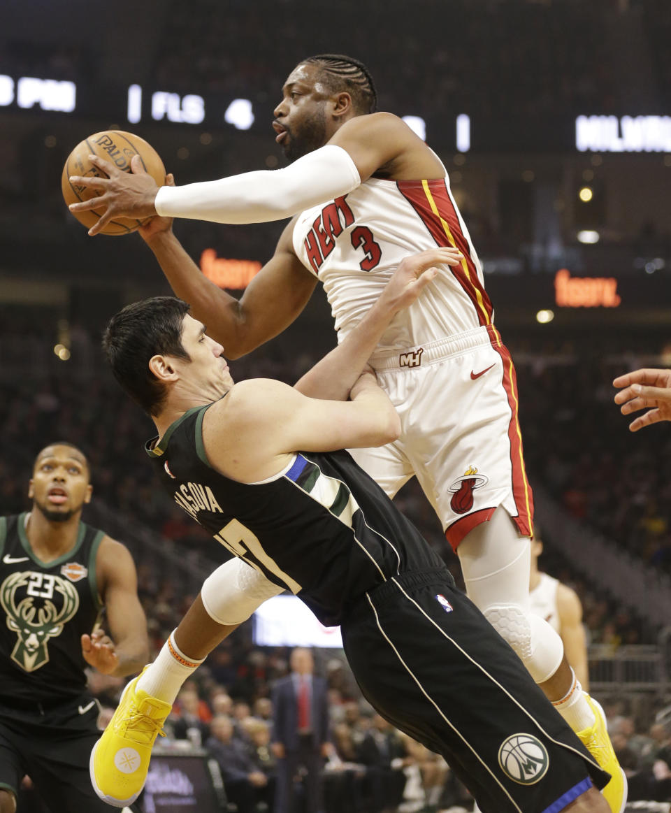 Miami Heat's Dwyane Wade (3) drives against Milwaukee Bucks' Ersan Ilyasova during the first half of an NBA basketball game Friday, March 22, 2019, in Milwaukee. (AP Photo/Jeffrey Phelps)