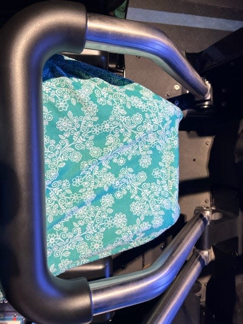 Accessible bucket-style seats secure  TRON Lightcycle / Run guests with a lap bar.