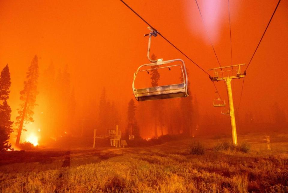 Flames from the Caldor fire surround a chair lift at Sierra-at-Tahoe ski resort on 29 August.