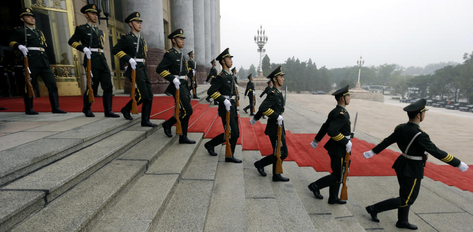 Chinese soldiers prepare for the arrival of German Chancellor Angela Merkel outside the Great Hall of the People in Beijing Thursday, Aug. 30, 2012. (AP Photo/Ng Han Guan)