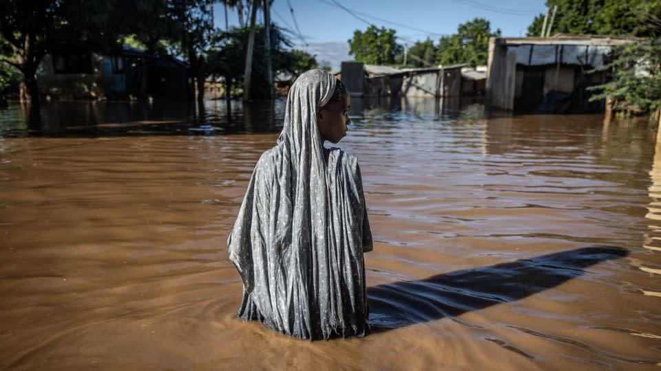 A woman wades through floodwaters at an inundated residential area in Garissa, Kenya, on May 9, 2024. - Luis Tato/AFP/Getty Images