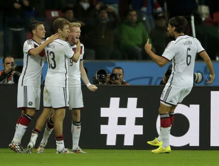 Germany's Andre Schuerrle (2nd R) celebrates his goal against Algeria with team mates during extra time in their 2014 World Cup round of 16 game at the Beira Rio stadium in Porto Alegre June 30, 2014. REUTERS/Henry Romero