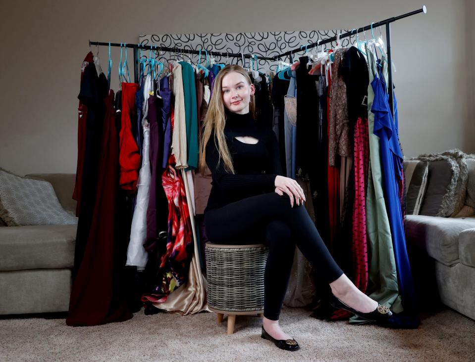 Isabella Mach, a junior at Northville High School in Northville stands with the prom dresses she has collected in her home in Northville on Friday, April 5, 2024.
Mach started up her own nonprofit, “A Princess PROMise,” with the goal to donate gently used prom dresses, shoes and other items for high schoolers who might not be able to afford dresses which can cost in the hundreds of dollars. Since getting the word out about asking for donated dresses she has received 54 dresses, 13 pairs of shoes, 7 purses and 9 suits.