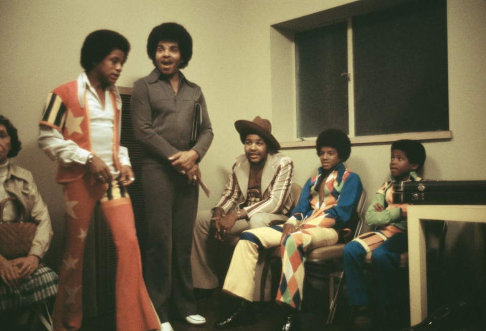 Michael Jackson sits with brothers Randy and Marlon and their father, Joe, backstage at the Inglewood Forum in 1973. Source: Getty