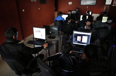 People use computers at an internet cafe in Ankara February 6, 2014. REUTERS/Umit Bektas