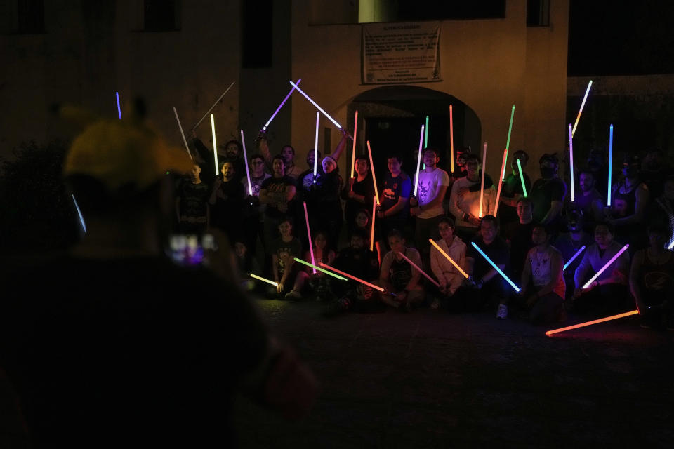 Students of the Jedi Knight Academy pose with their lightsabers at a park where they practice in Mexico City, late Saturday, June 15, 2024. The academy is a lightsaber combat and choreography school founded in 2019 and a dream come true for fans of Star Wars. (AP Photo/Eduardo Verdugo)