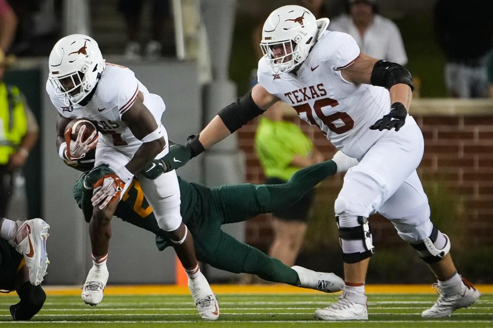 Texas guard Hayden Conner, right, blocks for Texas running back Keilan Robinson in a game against Baylor last season. Conner has started for two seasons at left gaurd but could get pushed for his starting spot by Neto Umeozulu in the summer.